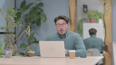 Middle Aged Businessman Shocked While Working on Laptop