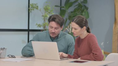 Creative Business People Discussing Online Work on Laptop