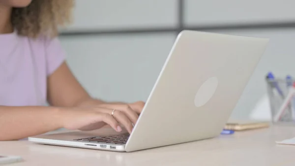 African American Woman Typing on Laptop Keyboard