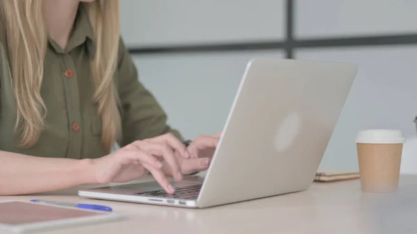 Blonde Young Woman Typing on Laptop Keyboard