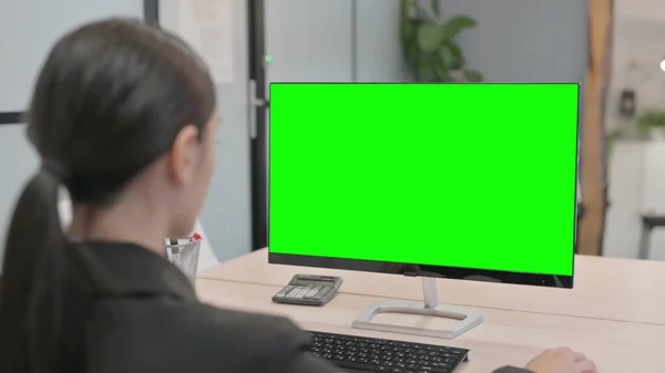 Young Businesswoman Working on Computer with Green Screen