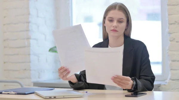 Businesswoman Working on Documents in Office, Paperwork