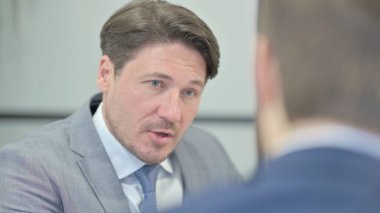 Close Up of Businessman Talking with Partner