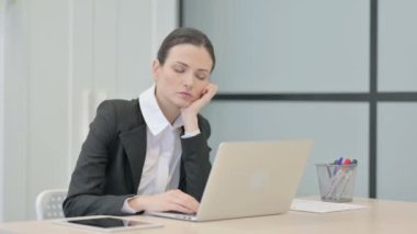 Businesswoman Sleeping while Sitting at Work