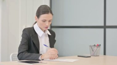 Businesswoman Working on Documents, Calculating Business Data