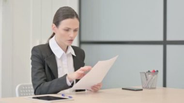 Businesswoman Upset by Loss while Reading Business Report