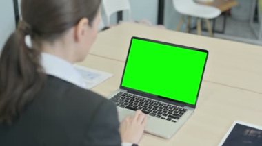 Businesswoman Working on Laptop with Green Chroma Screen