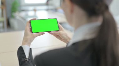 Businesswoman Holding Smartphone with Green Screen