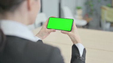 Businesswoman Watching Smartphone with Green Screen