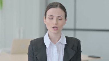 Businesswoman with Finger on Lips, Asking for Silence