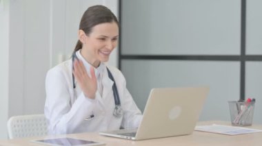 Young Doctor Doing Online Video Chat in Clinic
