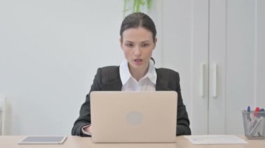 Young Businesswoman Coughing while Working on Laptop
