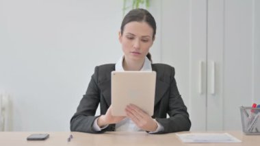 Young Businesswoman using Digital Tablet for Work