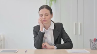 Young Businesswoman Sleeping while Sitting at Work
