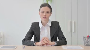 Successful Smiling Businesswoman Sitting in Office