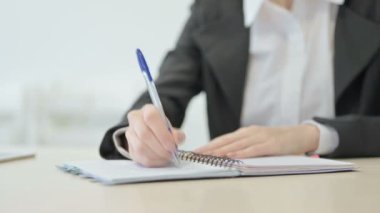 Close up of Businesswoman Writing in Office