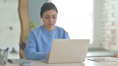 Dizüstü bilgisayar kullanırken boynu ağrıyan Hintli kadın