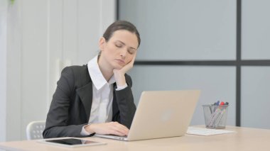 Businesswoman Sleeping while Sitting at Work