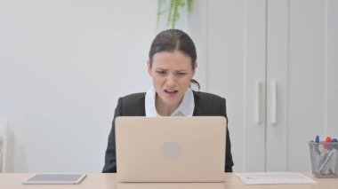 Young Businesswoman Reacting to Loss While Working in Office