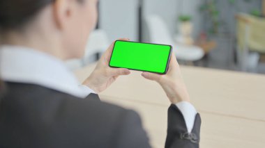 Businesswoman Watching Smartphone with Green Screen