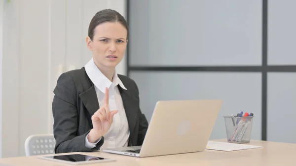 Businesswoman Shaking Head in Rejection while Working on Laptop