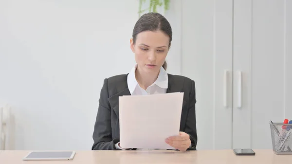 stock image Young Businesswoman Reading Documents in Office, Paperwork