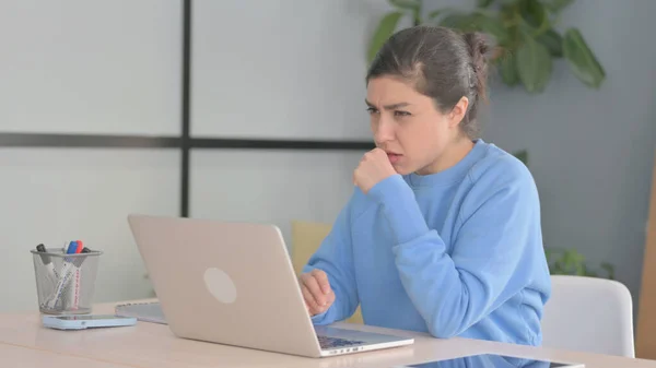 Indian Woman Coughing while Working on Laptop
