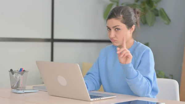 Indian Woman Shaking Head in Rejection while Working on Laptop