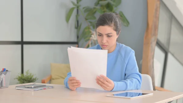 Indian Woman Reading Documents in Office, Paperwork