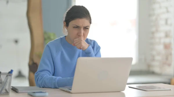 Indian Woman Coughing while Working on Laptop