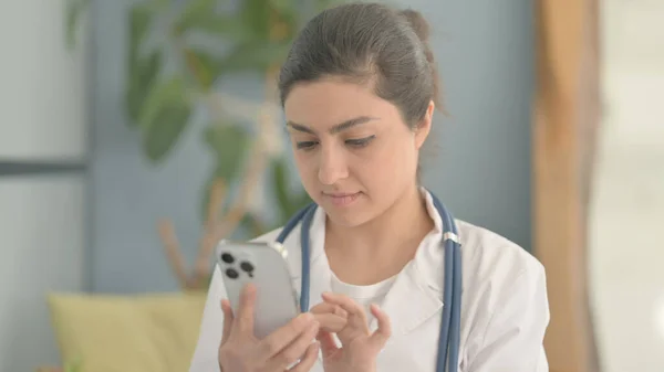 Portrait of Young Indian Doctor Using Smartphone