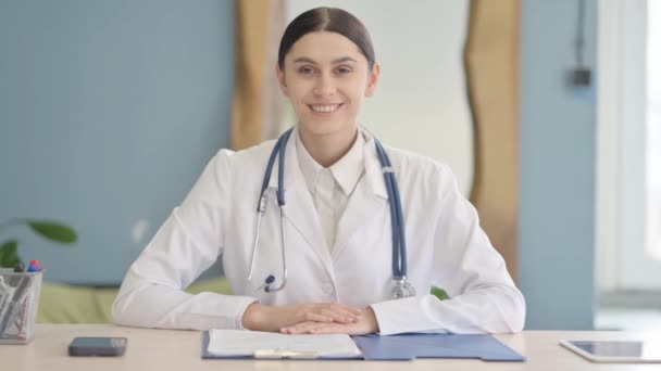 Sonriente Joven Doctora Mirando Cámara Clínica — Vídeos de Stock