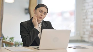 Genç iş kadını dizüstü bilgisayarda çalışırken diş ağrısı çekiyor, enfeksiyon kapmış.