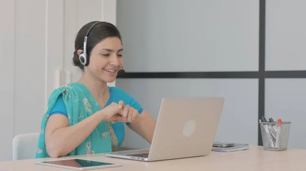 Young Indian Woman with Headset Talking with Customers Online in Call Center