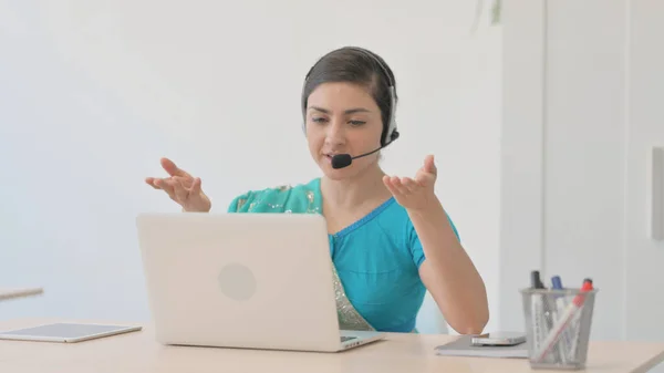 Indian Woman in Sari with Headset Talking with Customers Online in Call Center