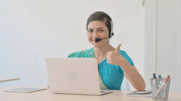 Thumbs Up by Indian Woman in Sari with Headset Working on Laptop in Call Center