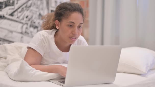 Афроамериканська Жінка Робить Відео Чат Ноутбуці Лежачи Стомаху Ліжку — стокове відео