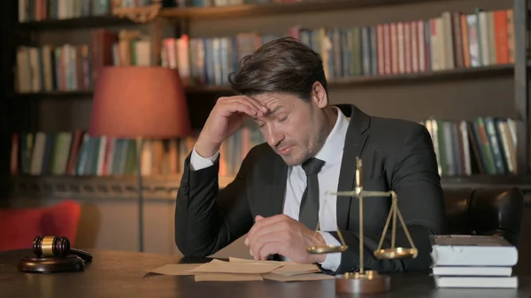 Tense Male Lawyer with Headache in Office