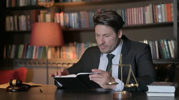 Male Lawyer Reading Law Book in Office