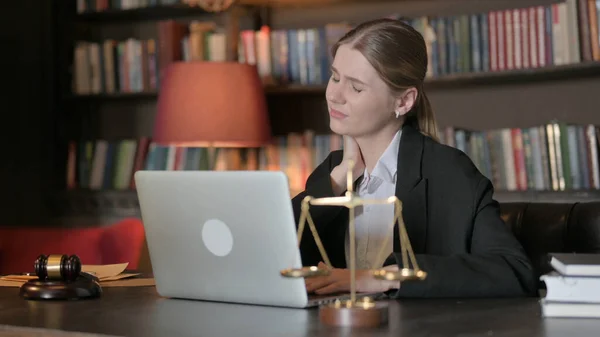 Female Lawyer with Neck Pain Working on Laptop