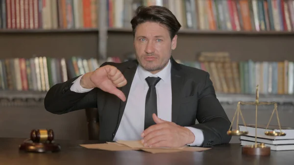 Male Lawyer Doing Thumbs Down in Office