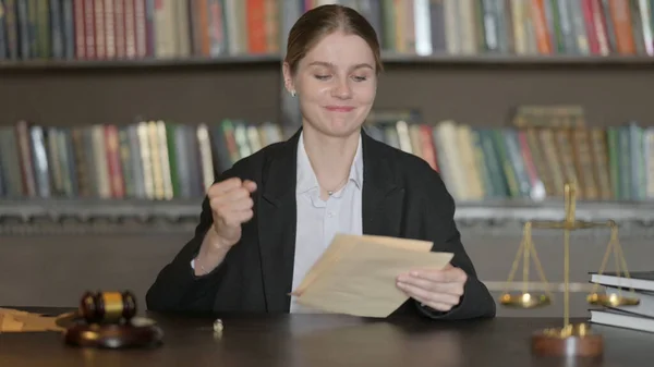 Excited Male Lawyer Reading Legal Documents in Office before Court