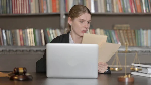 Female Lawyer Working on Legal Documents and Laptop