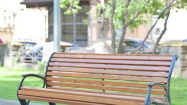 Middle Aged Businessman Coming and Sitting on Bench Outdoor