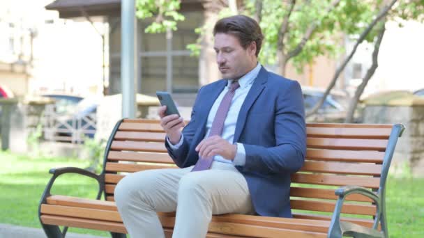 Empresario Mediana Edad Usando Smartphone Mientras Está Sentado Aire Libre — Vídeos de Stock