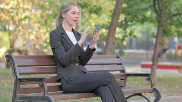 Businesswoman Celebrating Online Success Phone While Sitting Outdoor — Stock Video