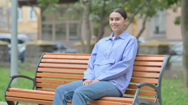 stock image Hispanic Woman Smiling at Camera  while Sititng Outdoor