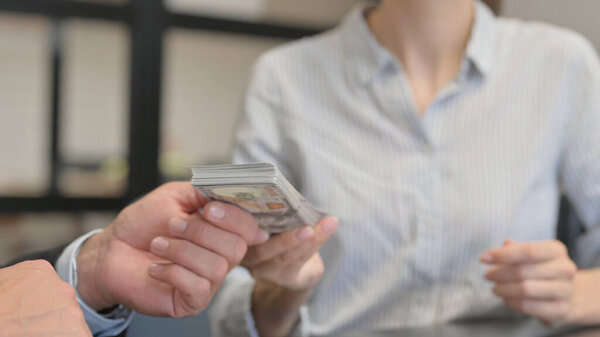 Close up of Businesswoman giving Money to Businessman