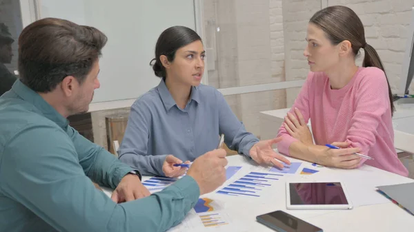 Indian Woman Discussing Plan with Teammates in Meeting