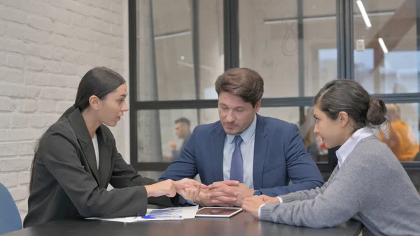 Angry Hispanic Businesswoman Having Argument with Colleagues